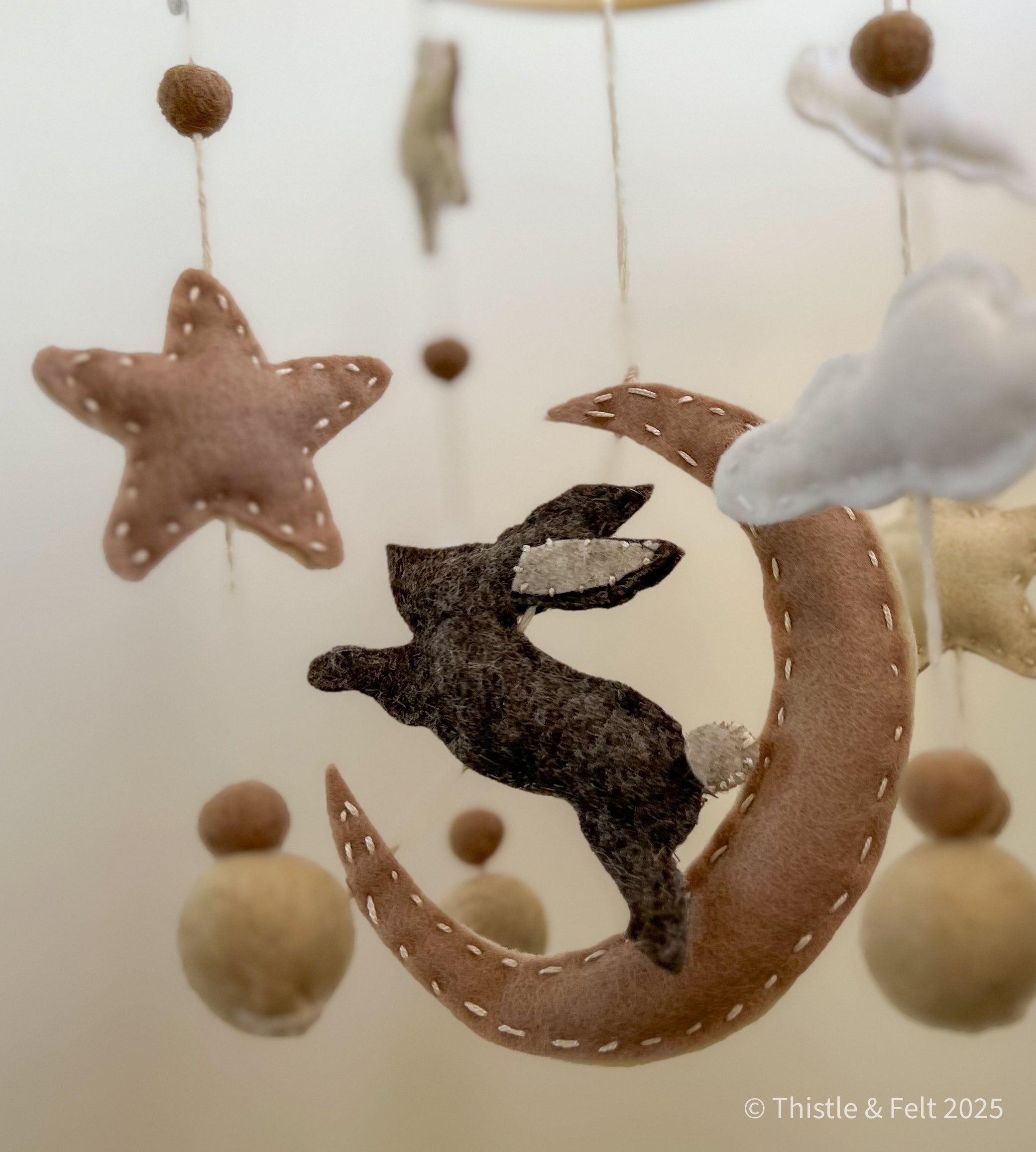 Lunar Lullaby Mobile  pure wool felt baby mobile with a bunny, stars, clouds and crescent moon in muted neutrals. For a serene nursery by Thistle & Felt.