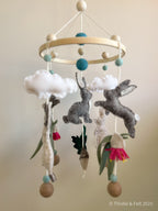 Handmade bunny felt nursery mobile with clouds by Thistle & Felt, perfect for natural nursery décor.