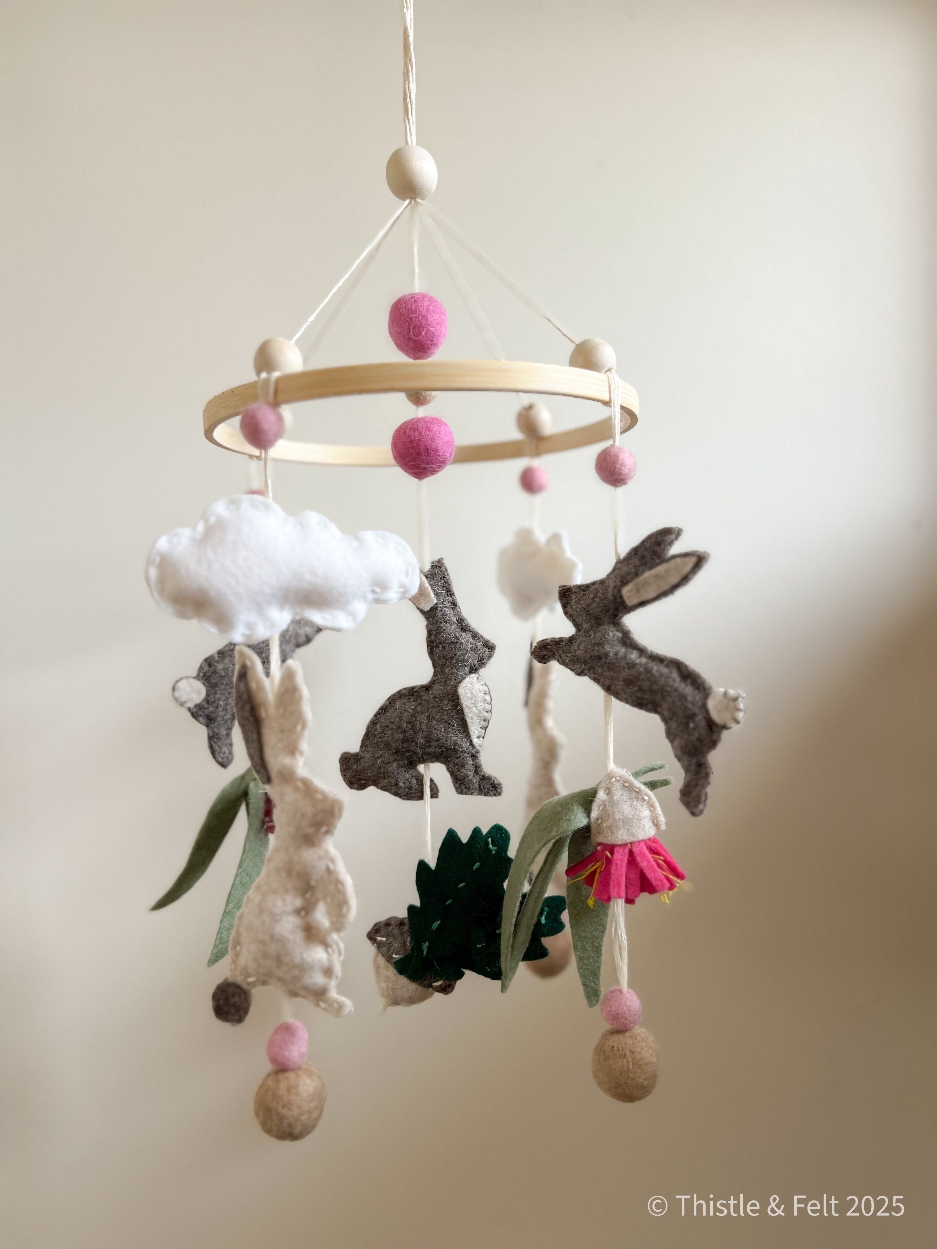 Handmade bunny felt nursery mobile with clouds by Thistle & Felt, perfect for natural nursery décor.