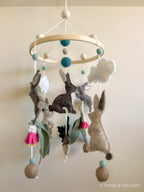Handmade bunny felt nursery mobile with clouds by Thistle & Felt, perfect for natural nursery décor.