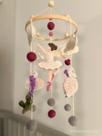 Handmade wool felt mobile featuring ballerina swans in soft pink and cream tones, inspired by classic fairytales.
