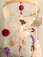 Handmade wool felt mobile featuring ballerina swans in soft pink and cream tones, inspired by classic fairytales.