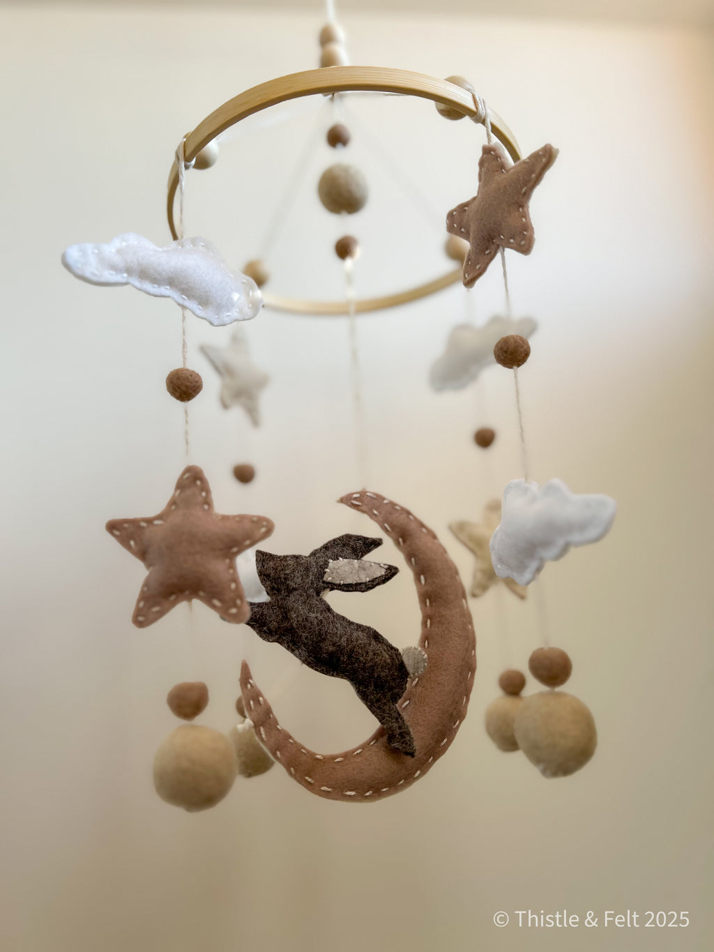Lunar Lullaby Mobile  pure wool felt baby mobile with a bunny, stars, clouds and crescent moon in muted neutrals. For a serene nursery by Thistle & Felt.