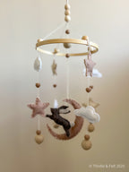 Handmade bunny felt nursery mobile with star and moon by Thistle & Felt, perfect for natural nursery décor.