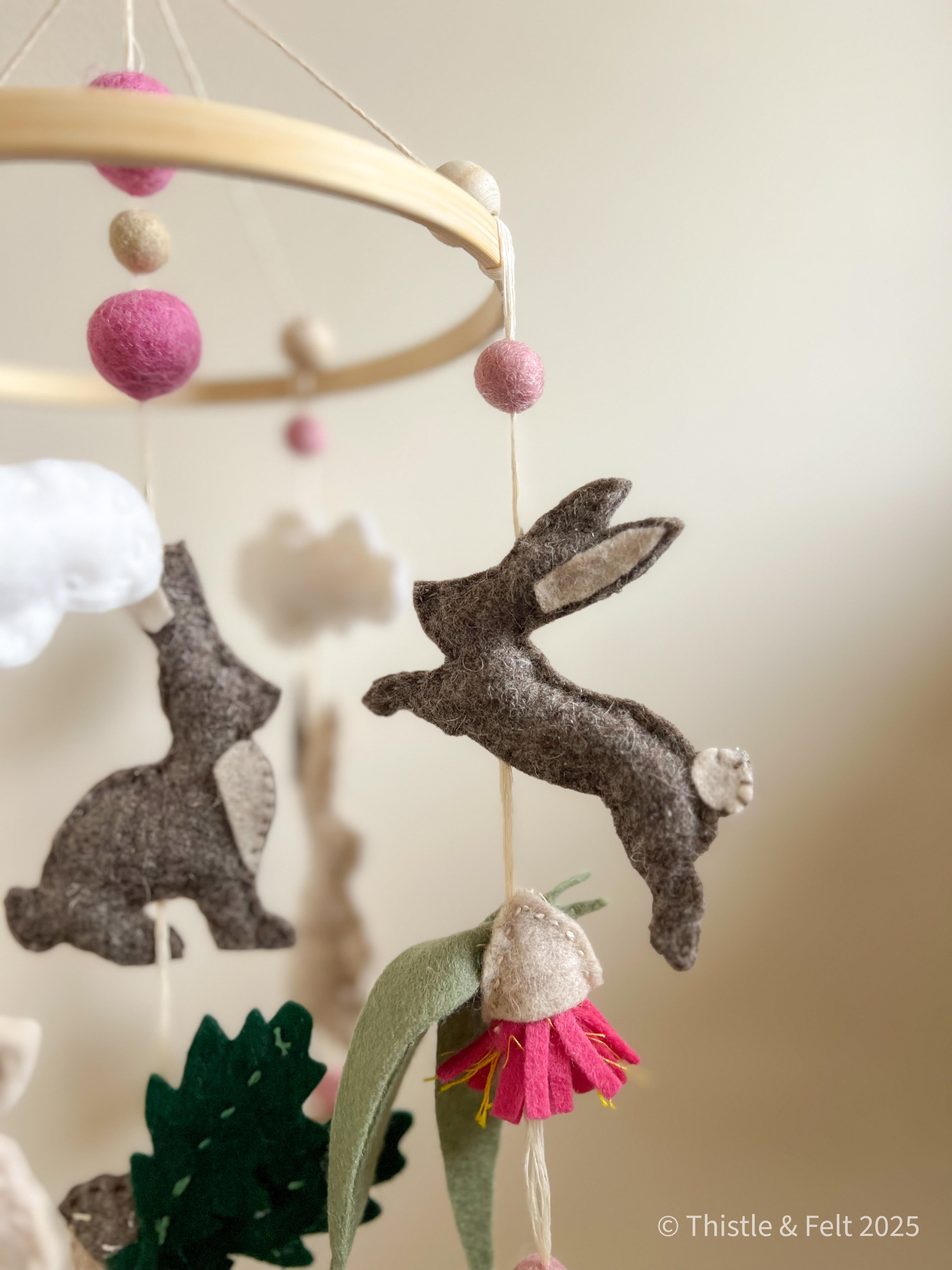 Handmade bunny felt nursery mobile with clouds by Thistle & Felt, perfect for natural nursery décor.