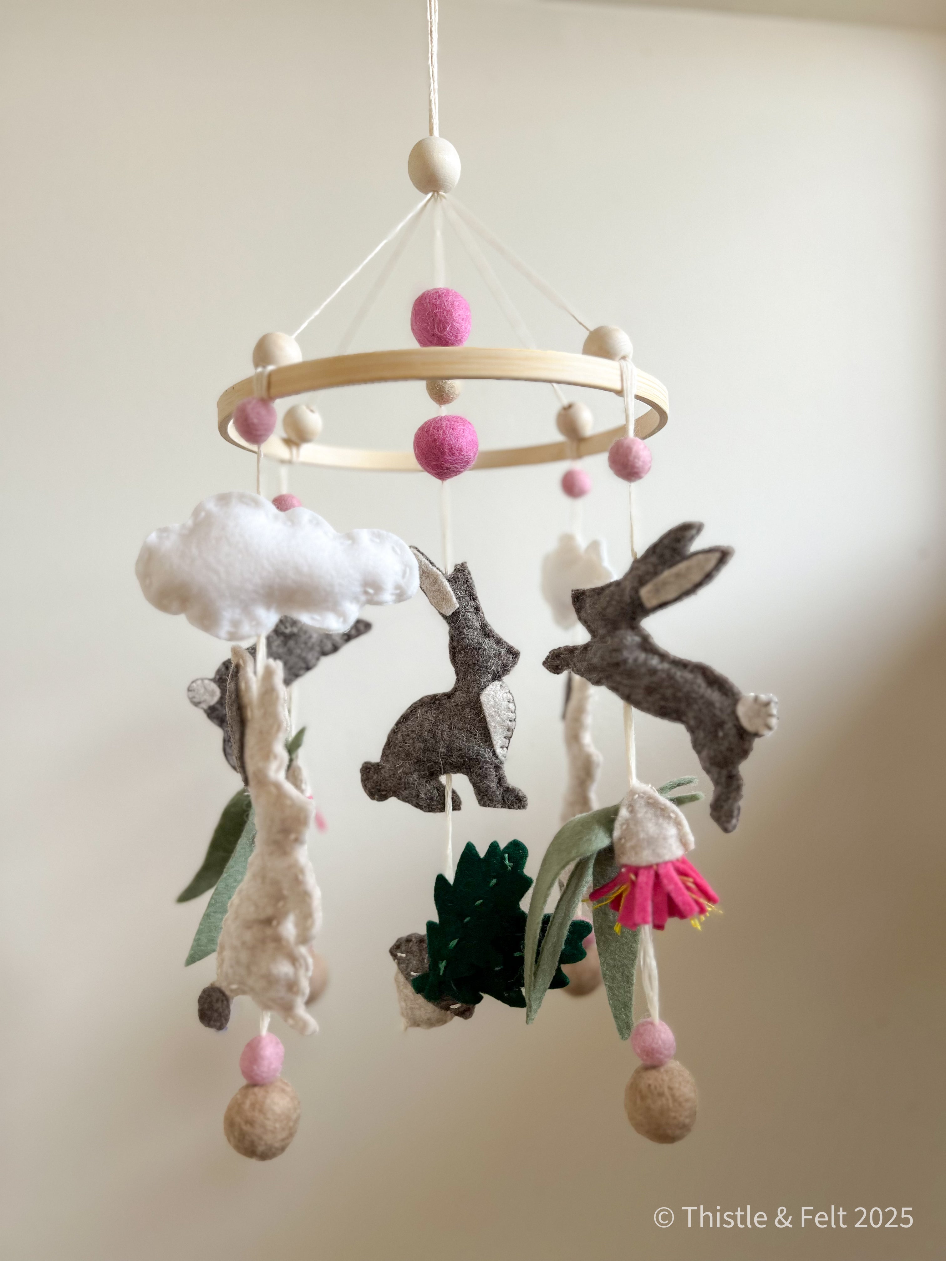 Handmade bunny felt nursery mobile with clouds by Thistle & Felt, perfect for natural nursery décor.