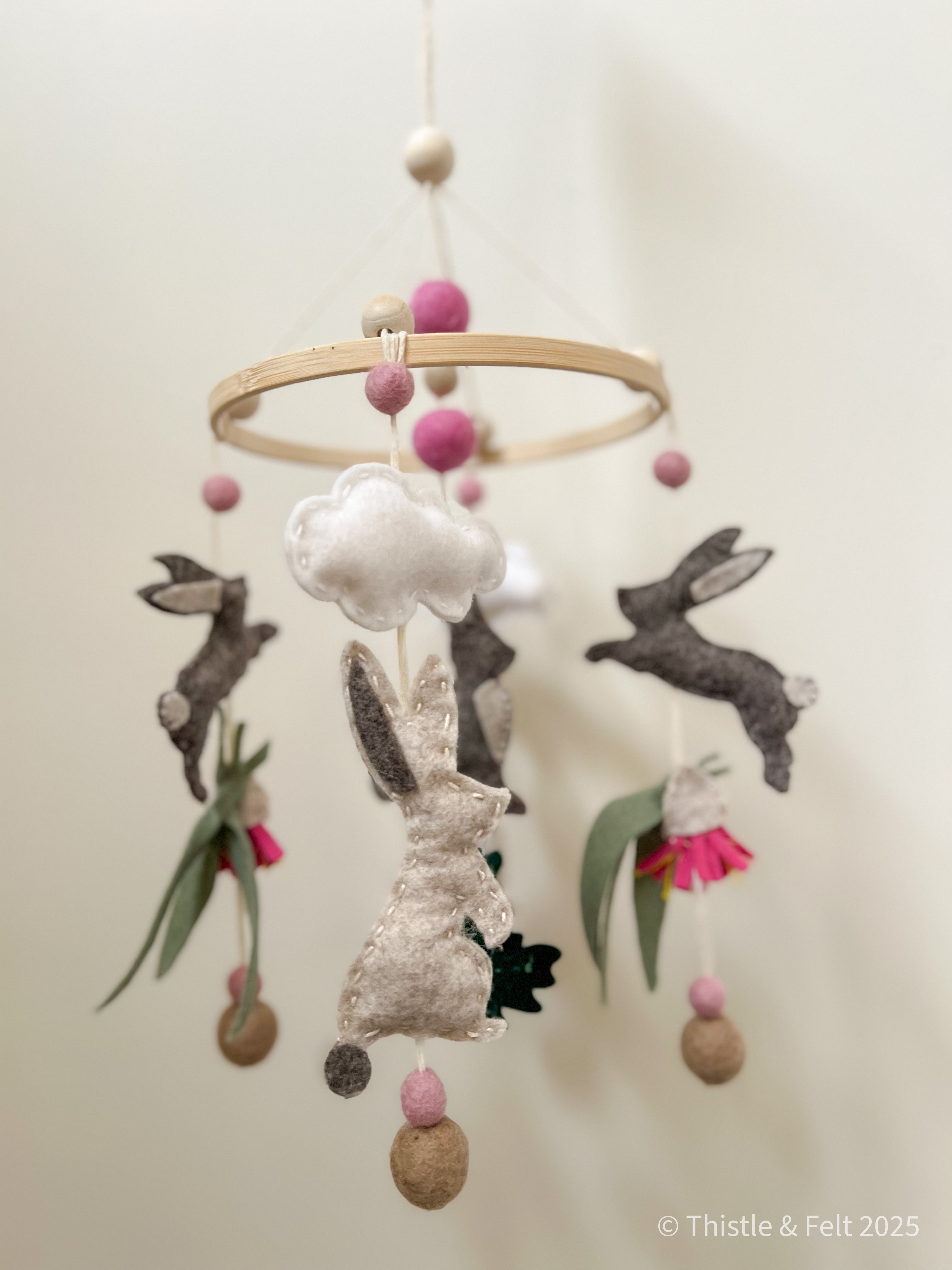 Handmade bunny felt nursery mobile with clouds by Thistle & Felt, perfect for natural nursery décor.