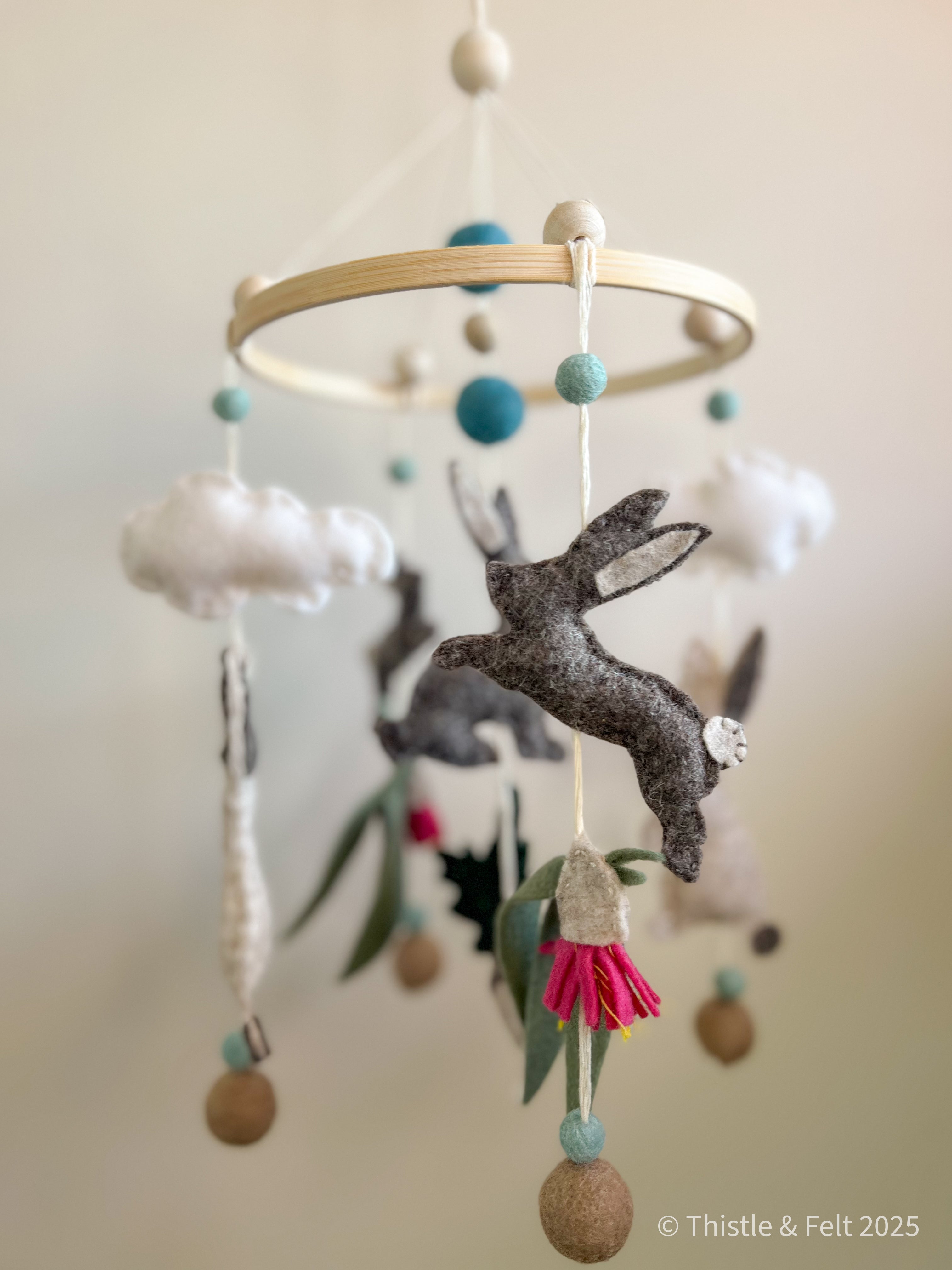 Handmade bunny felt nursery mobile with clouds by Thistle & Felt, perfect for natural nursery décor.
